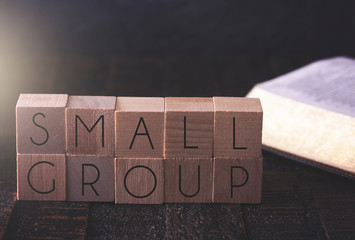 Small Group Spelled in Block Letters on a Table with a Bible