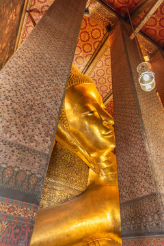 The Reclining Buddha at the Wat Arun Ratchawararam temple complex in the Bangkok.  The Buddha that measures 46 metres long and is covered in gold leaf.