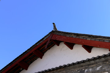 The corner of the ancient building against the blue sky