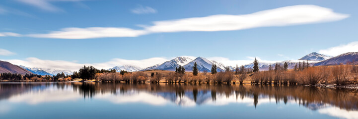 Mountain landscape, lake and mountain range, New Zealand landscape. NZ travel tourism. South island southern alps. Long exposure lake blurred water movement and motion. Silky smooth water.