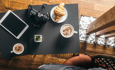 smart phone and Black fried coffee beans in cafe with cookie and cake on dark textured background
