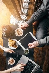 Young man in morning cafe drink coffee and read daily news