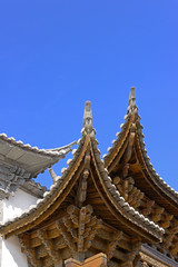 Fototapeta premium The corner of the ancient building against the blue sky