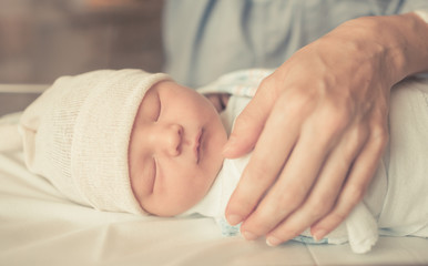 Fototapeta na wymiar newborn baby sleeping in bed