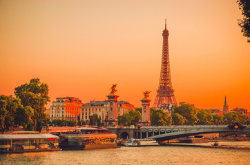 Sunset view of  Eiffel Tower, Alexander III Bridge and river Seine in Paris, France.