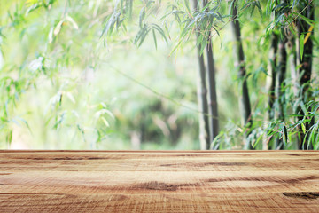 Empty wooden and blurred nature bamboo forest background.
