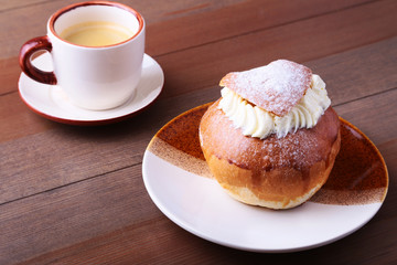 Traditional swedish dessert Semla, also called Shrove bun, with almond paste and whipped cream filling.