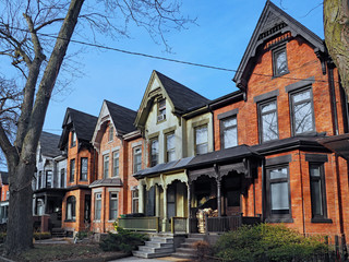 Fototapeta na wymiar Row of old Victorian style brick houses with gables