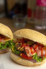 The cheesburger with grilled beef and bacon in rustic style.