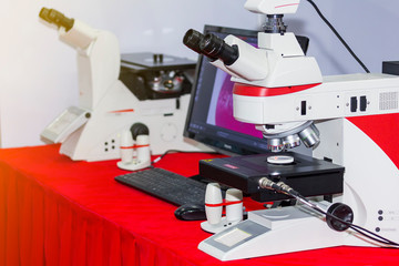 modern microscope for laboratory or industrial work connect with computer on table