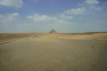 Dahshur, Egypt: An empty parking lot with a view of the Red Pyramid, the third pyramid built by Old Kingdom Pharaoh Sneferu.