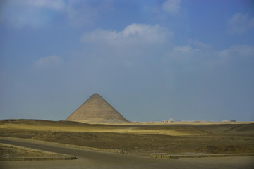 Fototapeta na wymiar Dahshur, Egypt: View of the Red Pyramid, the third pyramid built by Old Kingdom Pharaoh Sneferu.