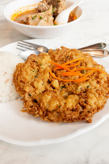 Rice with fried eggs and spicy pork ribs soup