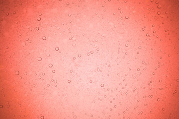 Rain droplets on red glass background, Water drops on glass.