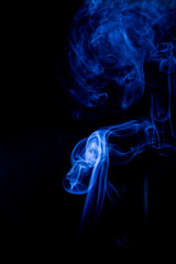 Fototapeta premium Blue toxic fumes movement on a black background.
