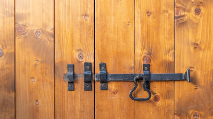 old sliding lock on rustic wooden door