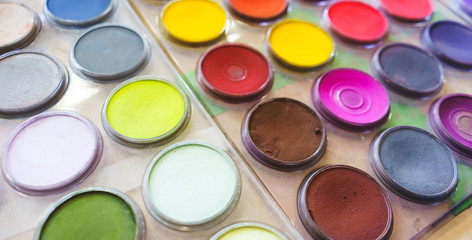 Pastel colors in a plastic round palette. 
