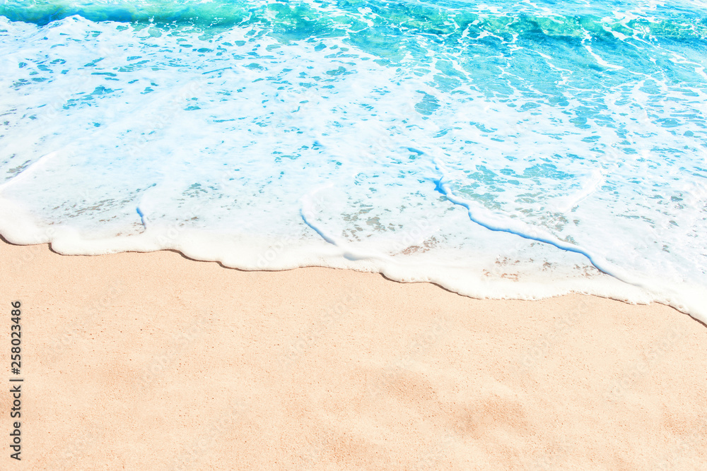 Sticker blue ocean wave on sandy beach. summer day and sand beach background