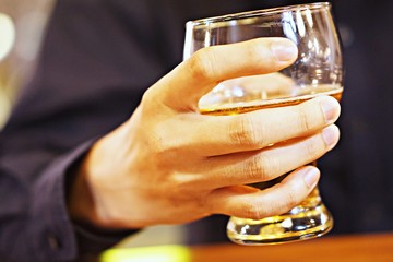A man holding a beer glass in his hand, for after work relax, 