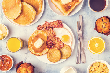 Healthy Full American Breakfast with Eggs Bacon Pancakes and Latkes.