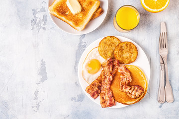 Healthy Full American Breakfast with Eggs Bacon Pancakes and Latkes.