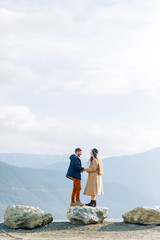 A beautiful couple travels in the mountains of Georgia. Lovestory in nature with a lake.