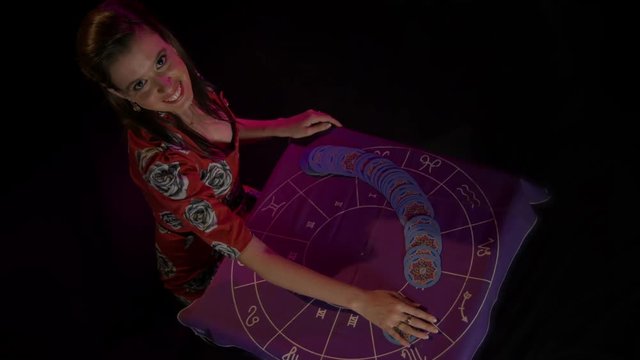 Tarot reader dealing cards & reading future and fortune. Top Shot.