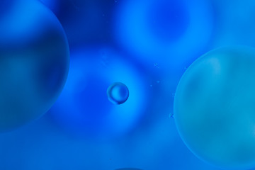 water drops on glass with blue background, close-up 