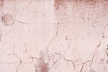 Old wall covered with cracked paint closeup as background and texture