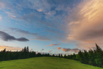 Journey through the mountain ranges and tops of the Ukrainian Carpathians, a tourist with a tent in a beautiful summer weather with fantastic sunrises and sunsets.