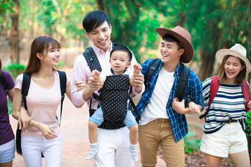 Group of young people with backpacks walking together