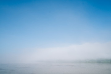 Fototapeta premium The sky, fog, and the river