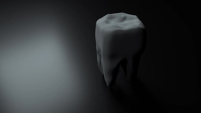 Tooth on black background. Loop. Isolated. Animation medical concept. 3d render
