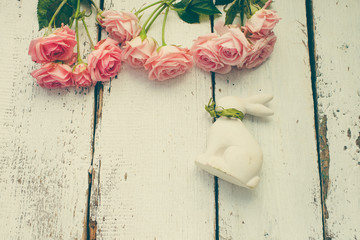 roses and bunny rabbit on wooden background