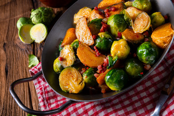 Brussels sprouts potato pan with bacon in rustic style