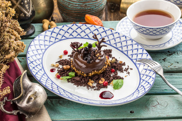 Black Forest chocolate dessert with cup of tea on blue wooden table