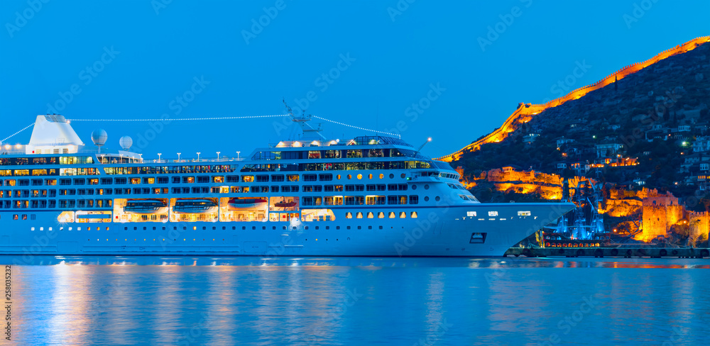 Wall mural Beautiful white giant luxury cruise ship on stay at Alanya harbor - Wall murals