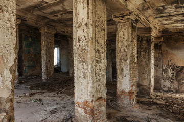 Fototapeta na wymiar Mystical interior, ruins of an abandoned ruined building of house of culture, theater of USSR. Old destroyed walls, corridor with garbage and dirt. Destroyed molding, plaster ornaments, bas-relief