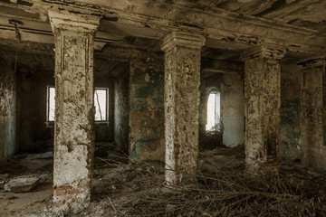 Mystical interior, ruins of an abandoned ruined building of house of culture, theater of USSR. Old destroyed walls, corridor with garbage and dirt. Destroyed molding, plaster ornaments, bas-relief