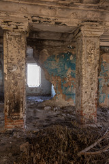 Mystical interior, ruins of an abandoned ruined building of house of culture, theater of USSR. Old destroyed walls, corridor with garbage and dirt. Destroyed molding, plaster ornaments, bas-relief