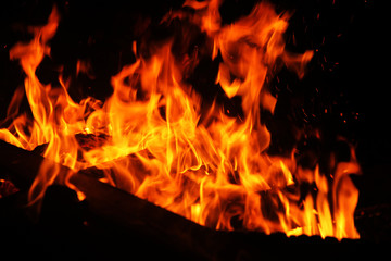 Fototapeta na wymiar Burning firewood and fire flame at night
