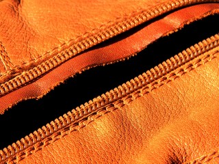 Genuine brown leather surface with zipper. Texture, background. template. Close up 