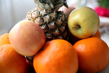 Naklejka na ściany i meble Tasty fruit background with orange, apples, pineapple