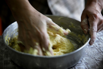 Fototapeta premium Making dough by female hands at bakery