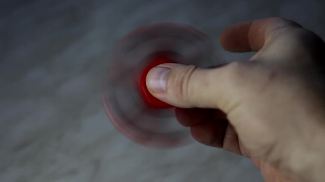 Rotating red spiner in hand