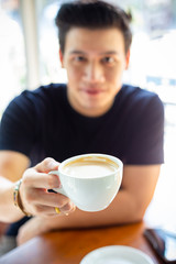 Young man holding a coffee cup