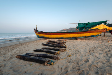 Old fishing boats on beach in Goa, India.