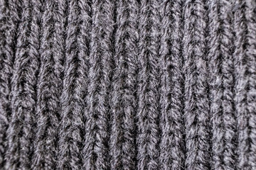 Fototapeta premium Knitted texture close-up, visible threads and fibers. The image is suitable as a background for various tasks.