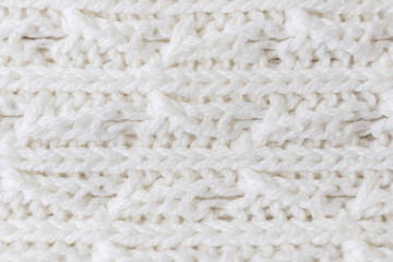 Light knitted texture closeup, visible yarn and fiber. The image is suitable as a background for various tasks.