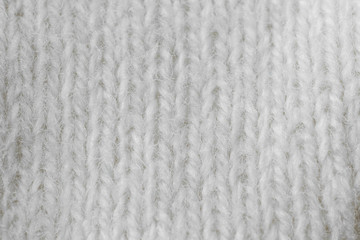 Light knitted texture closeup, visible yarn and fiber. The image is suitable as a background for various tasks.